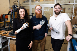A team of industrial design students at App State is taking a human-centered approach to innovation, using 3D printing technology to design and develop next-generation prosthetic hands that are both accessible and customizable for users. Pictured, from left to right, are App State assistant professor Jimena Vergara-Sanz, who leads the project in collaboration with associate professor Dr. Garner Dewey (not pictured); Davey West, lab operations manager in App State’s Department of Applied Design; and senior i